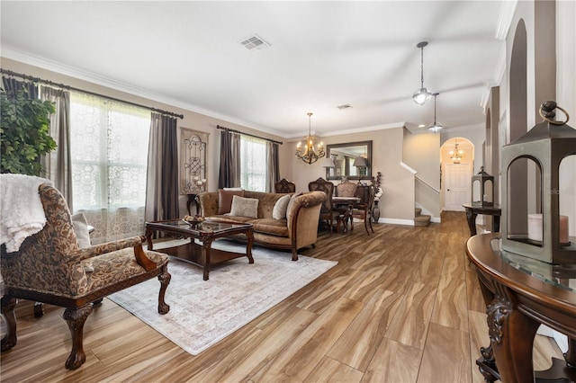 165 Mobbly Bay Dr, Oldsmar, FL 34677 - living room featuring a chandelier, ornamental molding, light wood-style flooring, and stairway