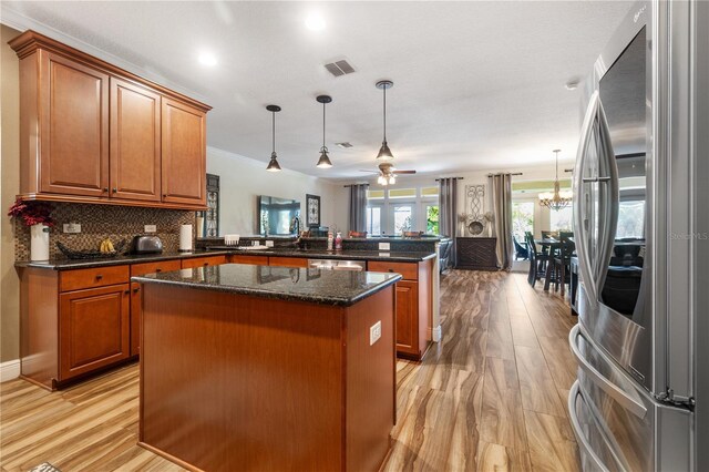 165 Mobbly Bay Dr, Oldsmar, FL 34677 - kitchen featuring smart refrigerator, a peninsula, a kitchen island, brown cabinets, and crown molding