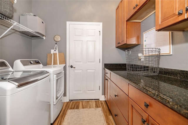 165 Mobbly Bay Dr, Oldsmar, FL 34677 - washroom with light wood finished floors, washer and clothes dryer, and cabinet space