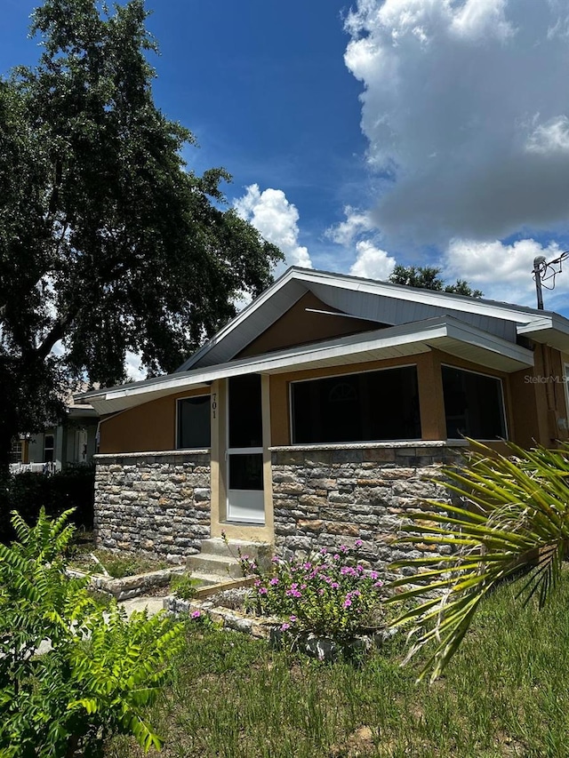 701 N 7th St, Haines City, FL 33844 - view of front facade with stone siding and stucco siding