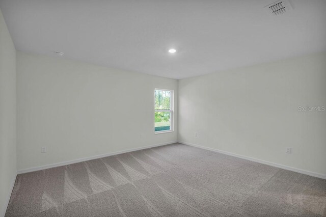 103 Whippoorwill Dr, Palm Coast, FL 32164 - carpeted empty room with baseboards and recessed lighting