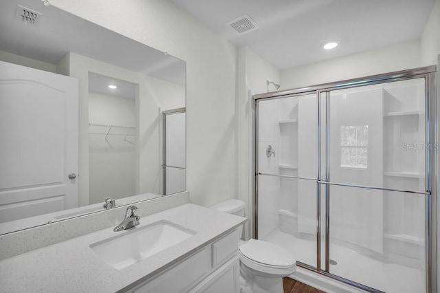 103 Whippoorwill Dr, Palm Coast, FL 32164 - full bath featuring a shower stall, vanity, wood finished floors, a walk in closet, and recessed lighting