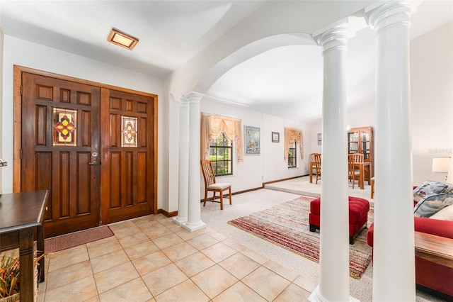 11307 Sandpine Rd, Riverview, FL 33569 - foyer entrance featuring ornate columns, arched walkways, light tile patterned flooring, and light colored carpet