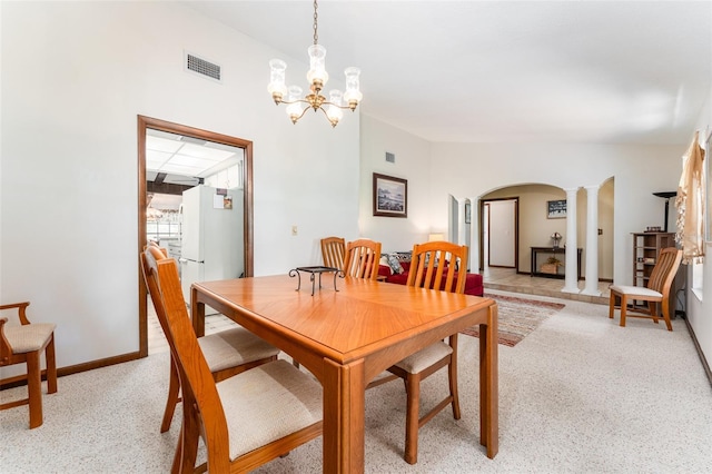 11307 Sandpine Rd, Riverview, FL 33569 - dining room with arched walkways, ornate columns, light carpet, and a chandelier