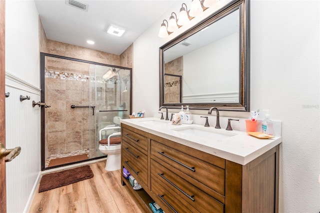 11307 Sandpine Rd, Riverview, FL 33569 - full bathroom featuring wood finished floors, double vanity, and a stall shower