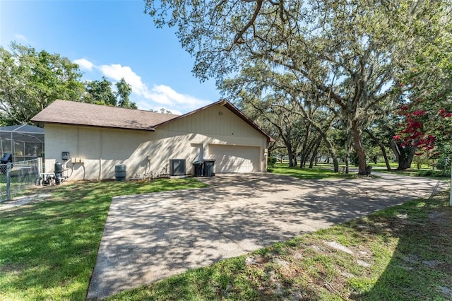 11307 Sandpine Rd, Riverview, FL 33569 - view of property exterior featuring asphalt driveway, an attached garage, and a lawn