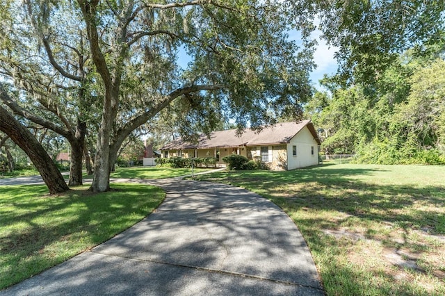 11307 Sandpine Rd, Riverview, FL 33569 - ranch-style house with a front lawn and driveway