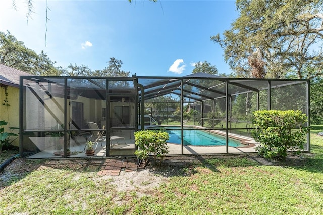 11307 Sandpine Rd, Riverview, FL 33569 - swimming pool featuring a patio, a lawn, and glass enclosure