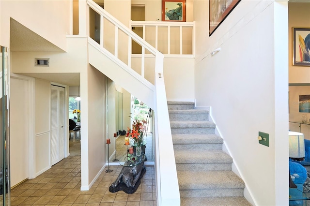 15917 Dover Cliffe Dr, Lutz, FL 33548 - stairway featuring tile patterned flooring and a high ceiling