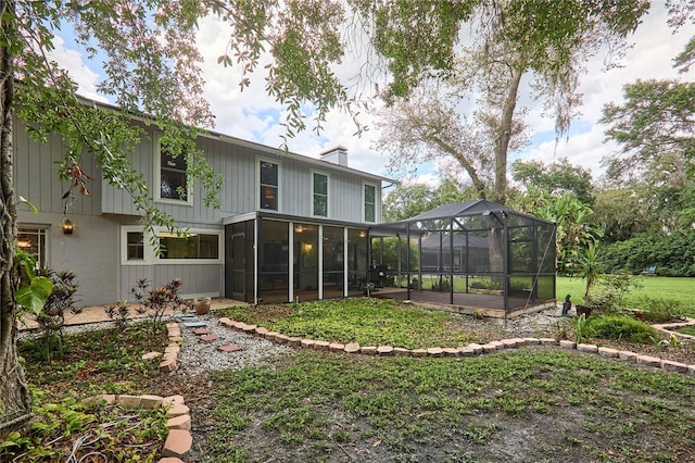 15917 Dover Cliffe Dr, Lutz, FL 33548 - rear view of property with a chimney, a lanai, a sunroom, and a yard