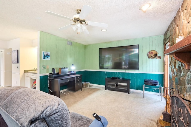 15917 Dover Cliffe Dr, Lutz, FL 33548 - living area with carpet floors, a ceiling fan, a textured ceiling, and a wainscoted wall