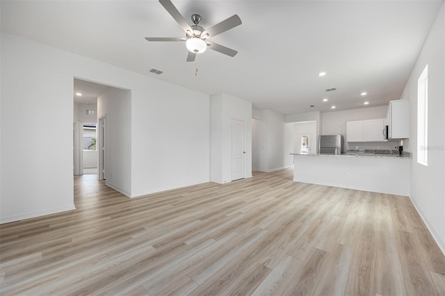 247 Big Sioux Dr, Poinciana, FL 34759 - unfurnished living room featuring a ceiling fan, light wood-style flooring, and recessed lighting