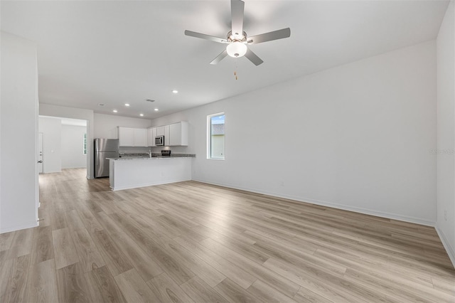 247 Big Sioux Dr, Poinciana, FL 34759 - unfurnished living room with light wood-style flooring, a ceiling fan, and recessed lighting