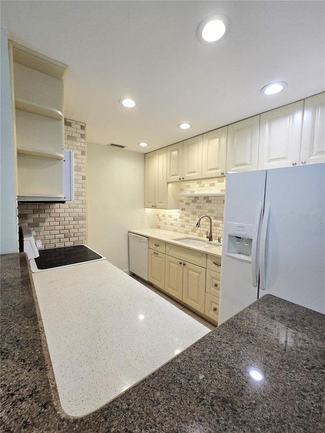 8300 Bardmoor Blvd Unit 110, Seminole, FL 33777 - kitchen featuring white appliances, backsplash, open shelves, dark stone countertops, and recessed lighting