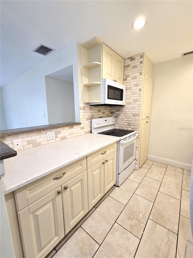 8300 Bardmoor Blvd Unit 110, Seminole, FL 33777 - kitchen featuring white appliances, backsplash, open shelves, and light stone countertops