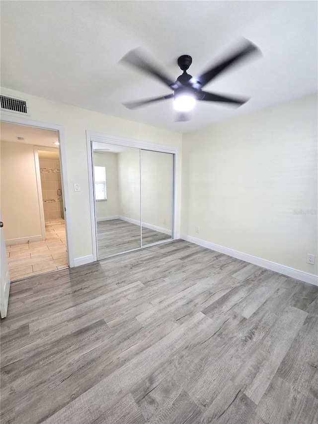 8300 Bardmoor Blvd Unit 110, Seminole, FL 33777 - unfurnished bedroom with a closet, wood finished floors, and ceiling fan