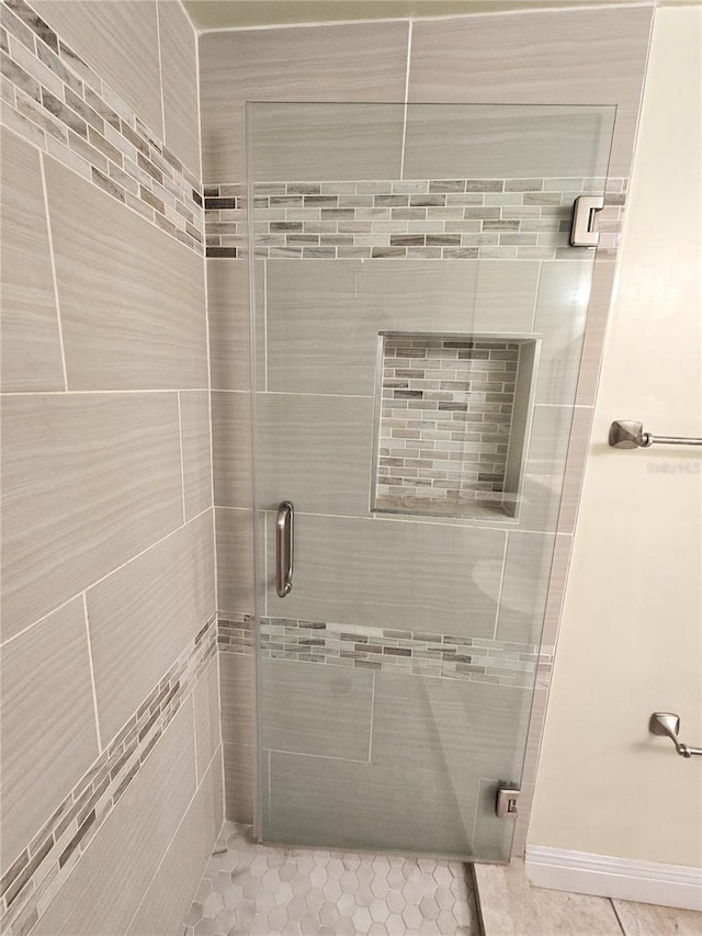 8300 Bardmoor Blvd Unit 110, Seminole, FL 33777 - bathroom featuring a shower stall and tile patterned flooring