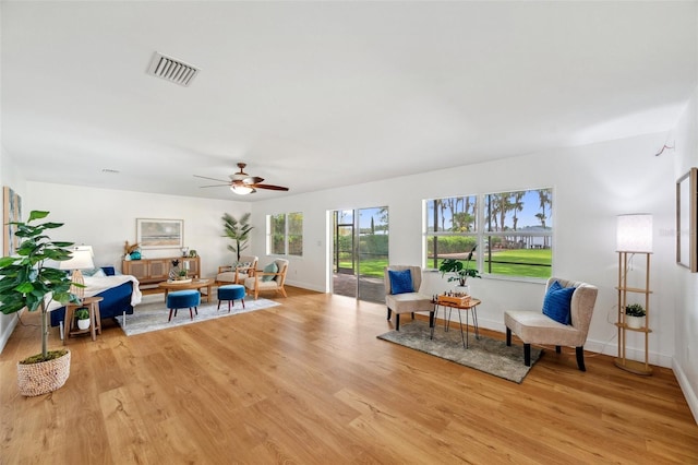 21906 Shamu Dr, Land O Lakes, FL 34639 - living area featuring light wood finished floors and ceiling fan