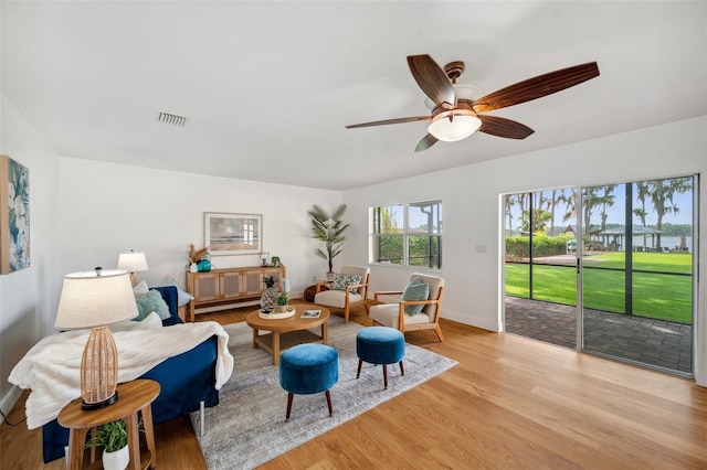 21906 Shamu Dr, Land O Lakes, FL 34639 - living room featuring light wood finished floors and ceiling fan