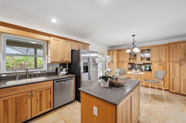 21906 Shamu Dr, Land O Lakes, FL 34639 - kitchen with stainless steel appliances, dark countertops, a center island, and hanging light fixtures