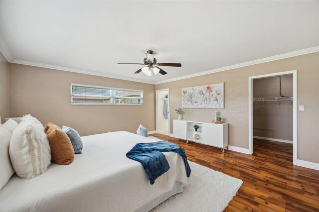 21906 Shamu Dr, Land O Lakes, FL 34639 - bedroom with crown molding, wood finished floors, a walk in closet, a closet, and ceiling fan