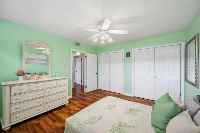 21906 Shamu Dr, Land O Lakes, FL 34639 - bedroom featuring multiple closets, dark wood-style floors, and a ceiling fan