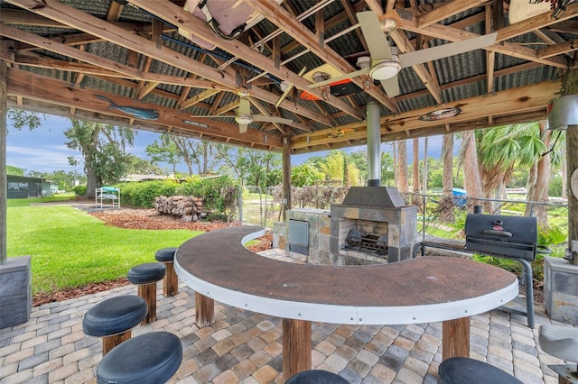 21906 Shamu Dr, Land O Lakes, FL 34639 - view of patio with a gazebo, an outdoor stone fireplace, and grilling area