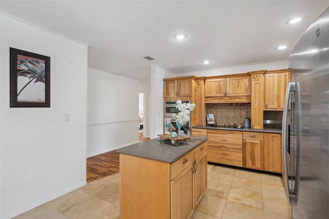 21906 Shamu Dr, Land O Lakes, FL 34639 - kitchen with stainless steel appliances, dark countertops, backsplash, a kitchen island, and recessed lighting