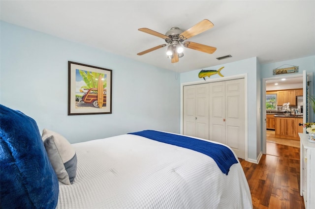 21906 Shamu Dr, Land O Lakes, FL 34639 - bedroom with dark wood-style floors, a closet, and ceiling fan