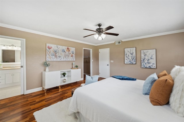 21906 Shamu Dr, Land O Lakes, FL 34639 - bedroom featuring crown molding, wood finished floors, a spacious closet, connected bathroom, and ceiling fan