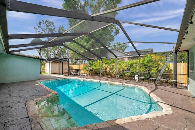 21906 Shamu Dr, Land O Lakes, FL 34639 - view of swimming pool featuring a patio area, a storage shed, a fenced backyard, and a lanai