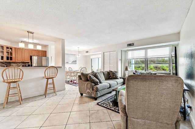 3315 58th Ave S Unit 311, Saint Petersburg, FL 33712 - living area featuring a textured ceiling and light tile patterned floors