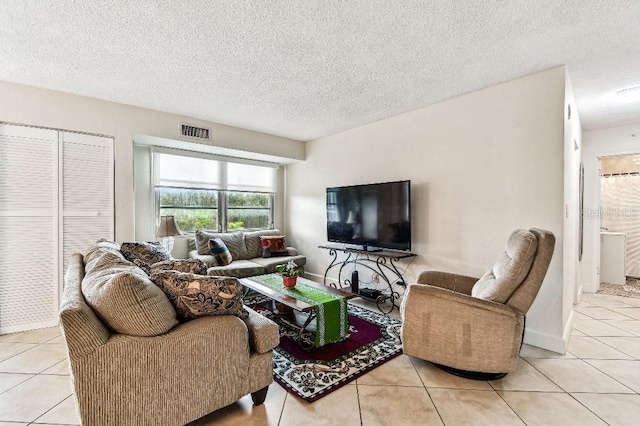 3315 58th Ave S Unit 311, Saint Petersburg, FL 33712 - living area featuring tile patterned flooring and a textured ceiling
