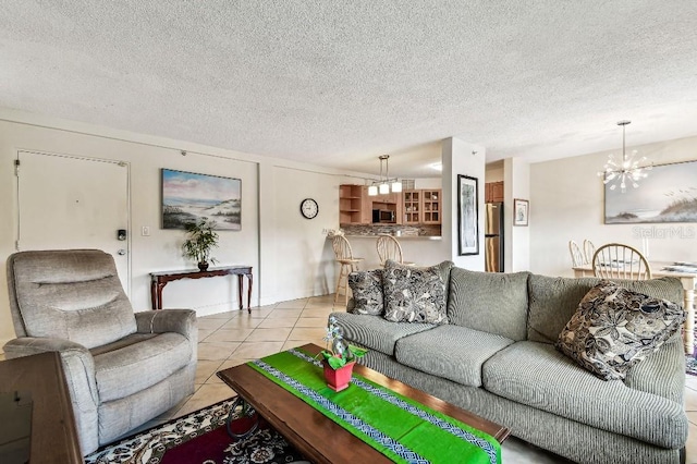 3315 58th Ave S Unit 311, Saint Petersburg, FL 33712 - living area featuring a chandelier, light tile patterned flooring, and a textured ceiling
