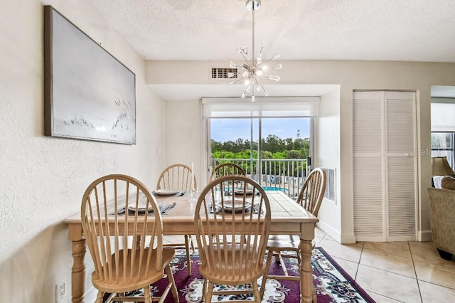 3315 58th Ave S Unit 311, Saint Petersburg, FL 33712 - dining space with a textured ceiling, a chandelier, a textured wall, and light tile patterned floors
