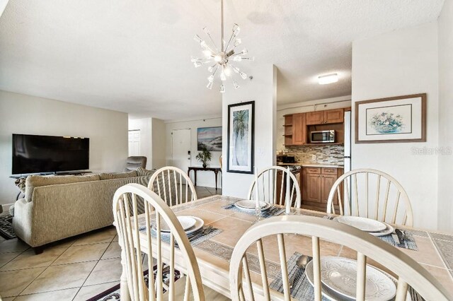 3315 58th Ave S Unit 311, Saint Petersburg, FL 33712 - dining room with light tile patterned flooring and a chandelier