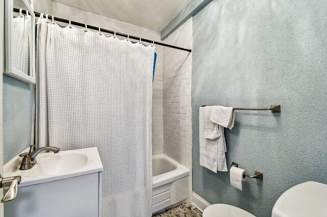 3315 58th Ave S Unit 311, Saint Petersburg, FL 33712 - full bathroom featuring vanity, shower / bath combo with shower curtain, and a textured wall