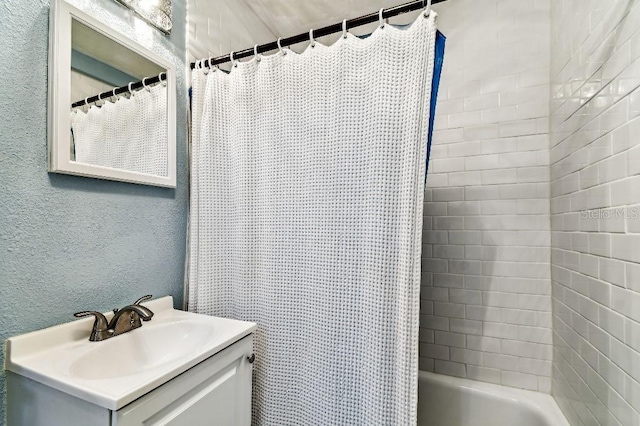3315 58th Ave S Unit 311, Saint Petersburg, FL 33712 - bathroom featuring vanity, a textured wall, and shower / bathtub combination with curtain