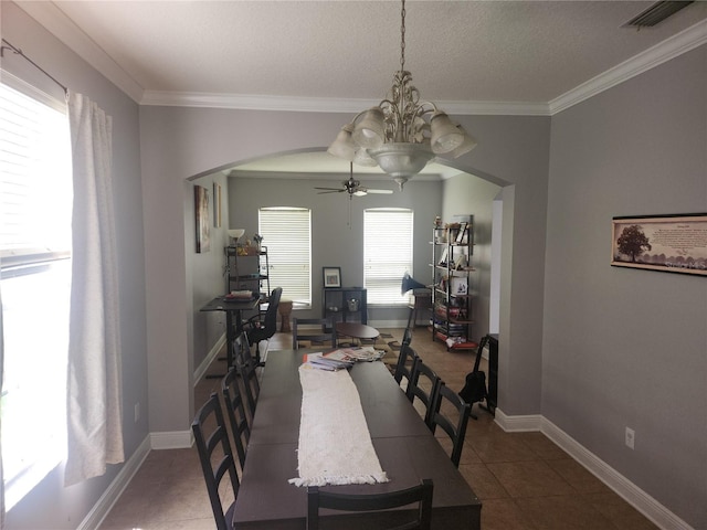 1753 Open Field Loop, Brandon, FL 33510 - tiled dining space with arched walkways, a ceiling fan, crown molding, and a textured ceiling