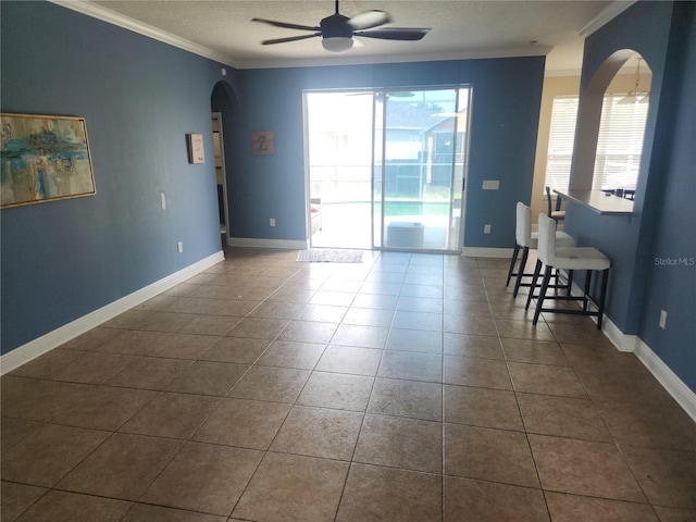 1753 Open Field Loop, Brandon, FL 33510 - unfurnished room with arched walkways, ornamental molding, ceiling fan, and dark tile patterned floors