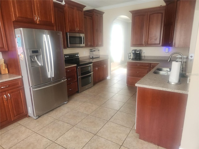 1753 Open Field Loop, Brandon, FL 33510 - kitchen featuring appliances with stainless steel finishes, ornamental molding, arched walkways, light tile patterned floors, and light stone counters
