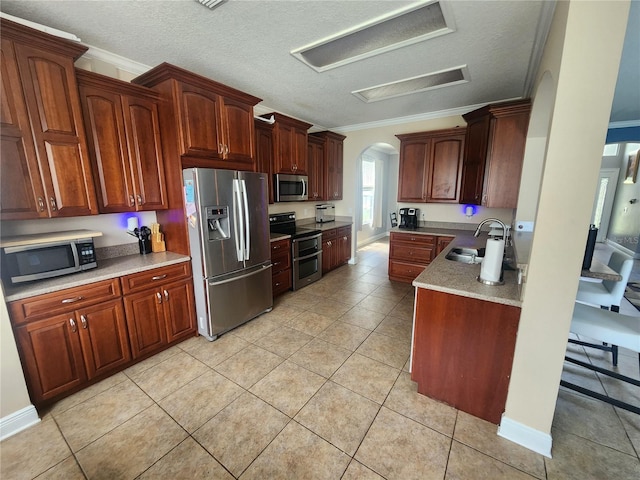 1753 Open Field Loop, Brandon, FL 33510 - kitchen with appliances with stainless steel finishes, arched walkways, ornamental molding, light tile patterned flooring, and a textured ceiling
