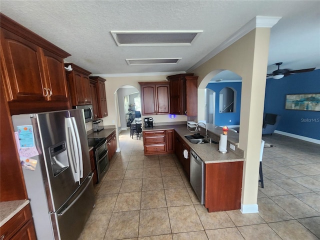 1753 Open Field Loop, Brandon, FL 33510 - kitchen with stainless steel appliances, ornamental molding, arched walkways, light tile patterned flooring, and ceiling fan