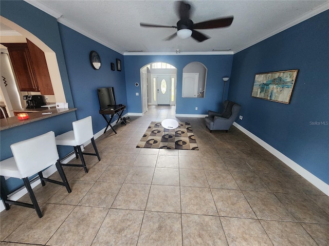 1753 Open Field Loop, Brandon, FL 33510 - tiled living area with arched walkways, a ceiling fan, ornamental molding, and a textured ceiling