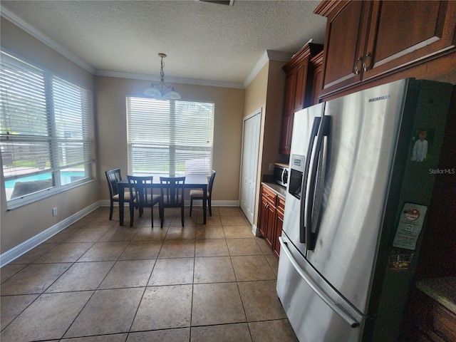 1753 Open Field Loop, Brandon, FL 33510 - kitchen featuring stainless steel appliances, crown molding, tile patterned floors, a chandelier, and decorative light fixtures