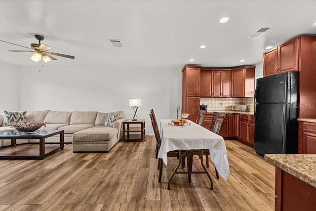 4945 91st Ave N Unit 30, Pinellas Park, FL 33782 - kitchen with freestanding refrigerator, a ceiling fan, light wood-style flooring, tasteful backsplash, and light countertops