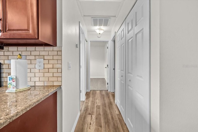 4945 91st Ave N Unit 30, Pinellas Park, FL 33782 - hallway featuring light wood-type flooring and baseboards