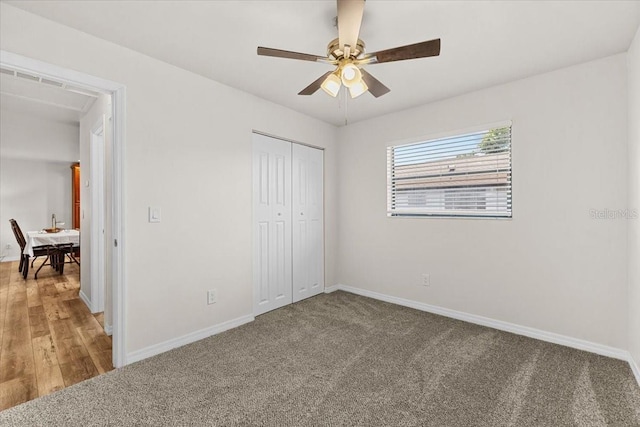 4945 91st Ave N Unit 30, Pinellas Park, FL 33782 - unfurnished bedroom featuring a closet, carpet, and a ceiling fan