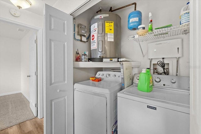4945 91st Ave N Unit 30, Pinellas Park, FL 33782 - laundry area featuring separate washer and dryer, water heater, and wood finished floors