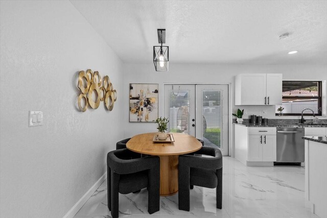 6370 Elmhurst Dr, Pinellas Park, FL 33782 - dining space featuring light marble finish flooring, healthy amount of natural light, french doors, and a textured ceiling